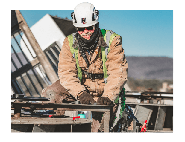 G. J. Hopkins worker working on a rooftop